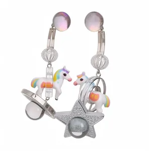Whimsical asymmetric resin pony and star earrings with silver posts and glitter details