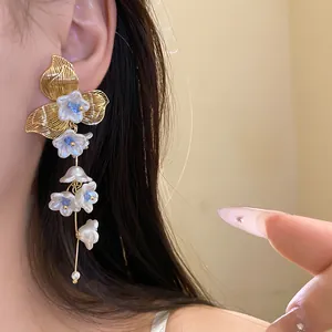 Elegant close-up shot of vintage flower tassel earrings with pearls worn by a model