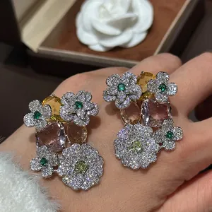Close-up view of elegant floral zircon earrings featuring colorful gemstones and pavé settings