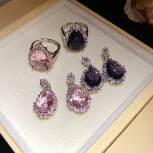 Detailed view of pear-cut pink and purple zircon jewelry set in a beige velvet box