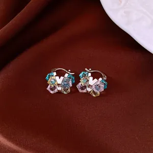 Detailed view of vintage colorful square crystal hoop earrings on elegant brown fabric background