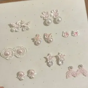 Detailed view of sweet Korean style pink enamel and pearl stud earrings collection