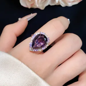 Detailed macro view of a luxury pear-shaped purple zircon ring featuring halo crystals