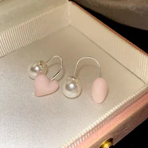 Close-up detail showing the sweet pink heart and pearl design of these exquisite earrings