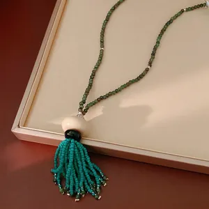 Vintage ethnic beaded resin tassel necklace with green beads and turquoise accents