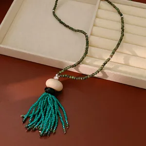 Detailed macro view of vintage beaded necklace with elegant turquoise tassel
