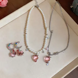 Detailed view of pink resin strawberry pearl necklace and matching zircon earrings set