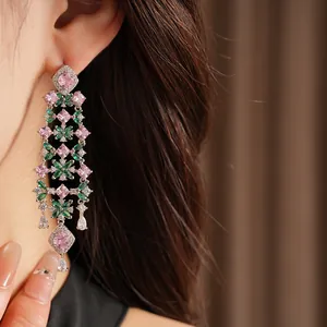 Detail shot of elegant 18k gold plated zircon flower tassel earrings worn on ear