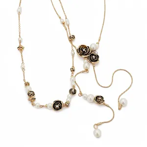 Vintage style pearl necklace with black rose charms and rhinestone accents on gold chain