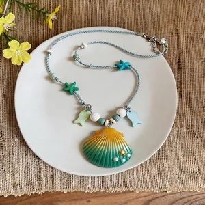Handmade summer beach ceramic shell and starfish pendant necklace with blue braided cord