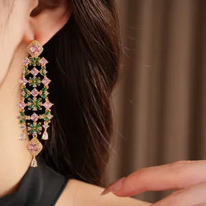 Close-up view of 18k gold plated flower tassel earrings with pink and green zircon stones
