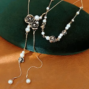 Close-up of pearl and black flower necklace with rhinestone detailing on velvet box