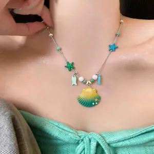 Close-up of a summer resort style ceramic necklace featuring sea shell and starfish charms