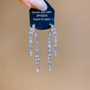 Detailed macro view of elegant silver drop earrings with faceted cubic zirconia