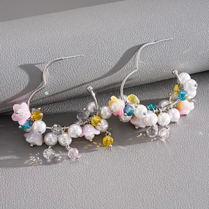 Detailed macro shot of heart hoop earrings featuring colorful glass beads and pearls