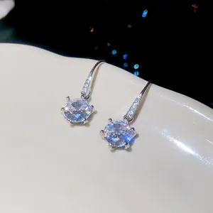 Close-up of micro-paved cubic zirconia round ear hook earrings with minimalist luxury design.