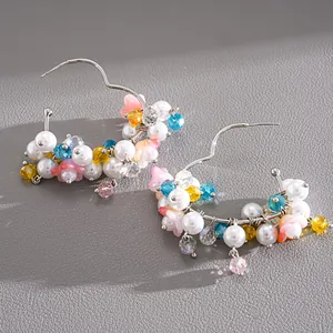 Detailed view of dopamine-style heart hoop earrings with colorful glass beads and pearls