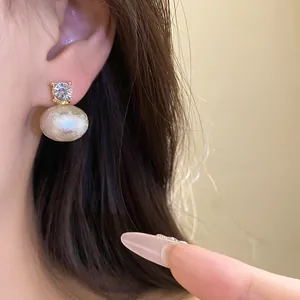 Close-up view of French retro cotton pearl earrings with sparkling zircon detail