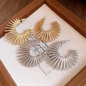 Elegant sunburst geometric C-shaped hoop earrings in gold and silver finish, pair