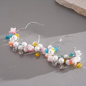 Detailed view of dopamine style hoop earrings with colorful glass beads and pearls