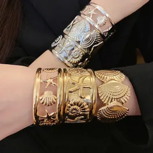 Gold and silver hollow starfish and seashell open cuff bracelets with a beach theme design