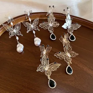 Elegant French style hollow butterfly earrings with pearls and teardrop stones.