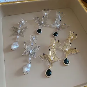 Elegant hollow butterfly earrings with teardrop pearls and black crystal accents