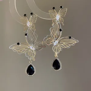 Detailed view of French-style hollow butterfly earrings with black water drop pendants.