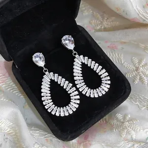 Elegant silver teardrop dangling earrings with white zircon in a black jewelry box.