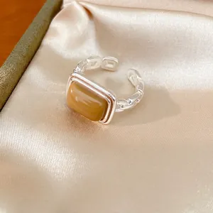 Elegant silver-toned chain open ring featuring a stylish rectangular amber resin stone.