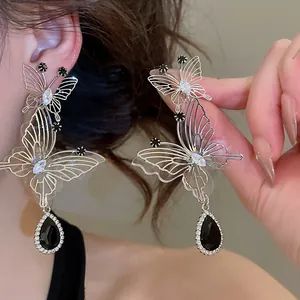 Elegant hollow butterfly earrings with black teardrop crystal dangles for daily wear.