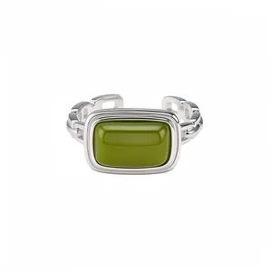 Minimalist silver open ring featuring a large rectangular olive green resin stone inlay.
