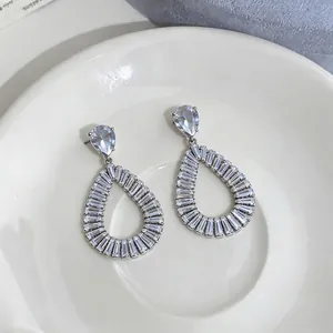 Elegant silver teardrop earrings with hollow design and baguette-cut zircons