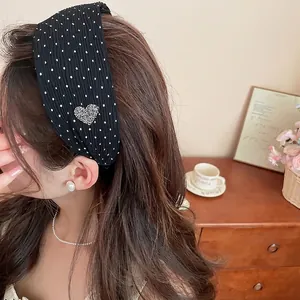 Korean style black polka dot wide brim headband with rhinestone heart on model