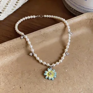 Elegant handmade pearl choker with heart zircons and light blue enamel daisy charm