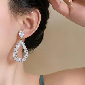 Exquisite close-up of silver zircon water-drop earrings with baguette-cut stones