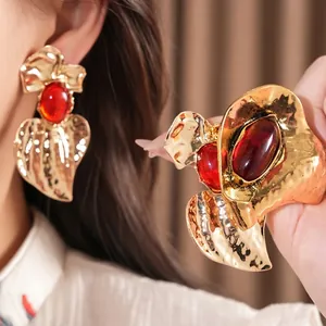 Dramatic gold hammered finish earrings featuring a large oval red resin stone for women