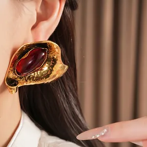 Statement vintage gold exaggerated resin stud earrings with oval red gemstone center