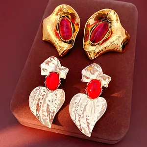 Detailed shot of luxury geometric resin stud earrings with gold and silver hammered metal