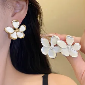 Retro floral stud earrings in elegant white and gold finish for women's jewelry collection.