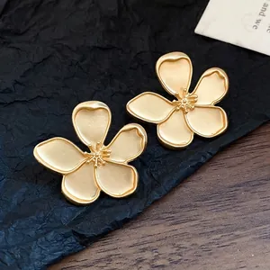 Vintage matte gold flower stud earrings with five-petal design and textured center