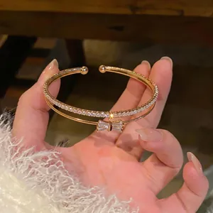 Bracciale rigido a doppio strato in oro di lusso francese con zirconi e un fiocco