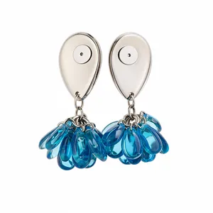 Elegant silver-tone stud earrings with blue resin teardrop tassels on a pure white background