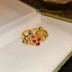 Vintage gold-plated floral open ring with colorful zircon stones in a jewelry box