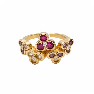 Vintage gold-toned open ring with floral zircon clusters and red gemstones