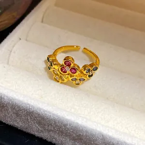 Close-up of vintage gold flower open ring with colorful zircon stones in jewelry box