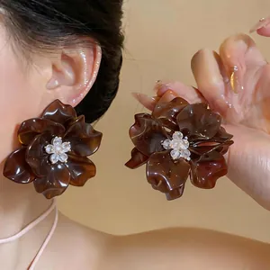 Elegant oversized brown flower stud earrings with shimmering glass beaded center cluster