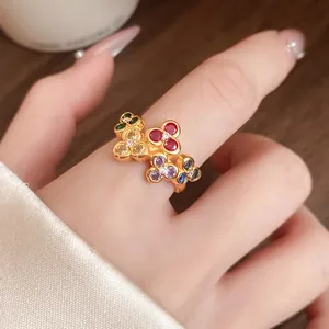 Close-up detail of a vintage gold flower ring featuring vibrant colorful zircon stones