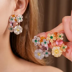 Vintage style zircon flower earrings featuring colorful oval gemstones worn by model