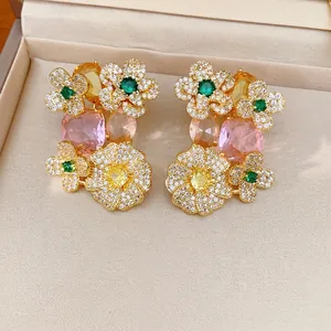 Exquisite vintage flower stud earrings with colorful zirconia stones in a cream jewelry box